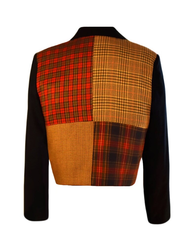 May include: A black blazer with a patchwork design on the back. The patchwork is made up of four different plaid fabrics in red, black, brown, and white.