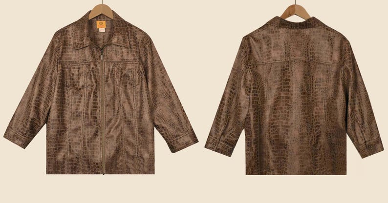 May include: Brown faux leather jacket with a crocodile skin texture, displayed on a wooden hanger. The jacket has a collared neckline, a zip-up front, and two chest pockets. The back of the jacket is also visible.