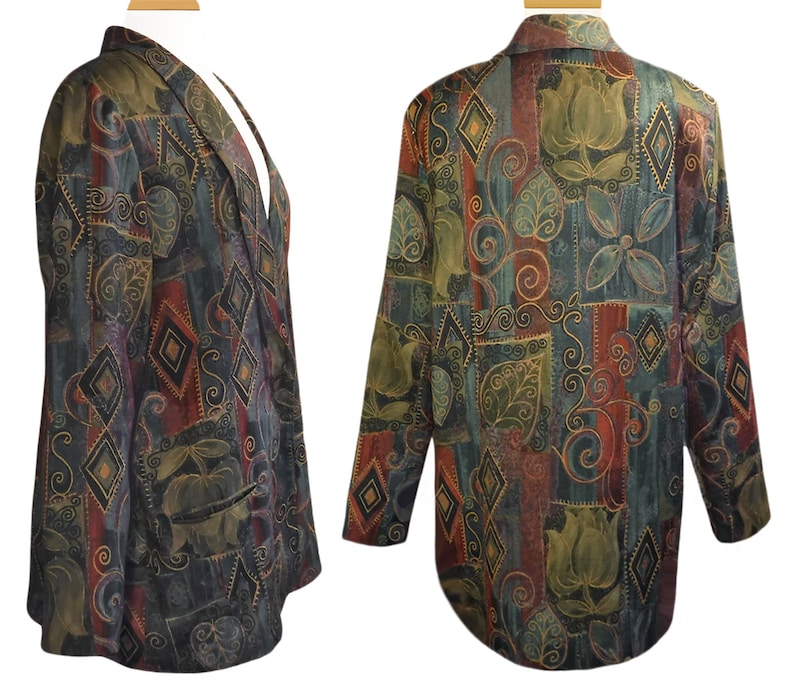 May include: A patterned blazer with a mix of colors including green, red, and gold. The blazer features a unique design with floral and geometric shapes. The jacket has a notched collar and two front pockets. The fabric appears to be a soft, textured material.