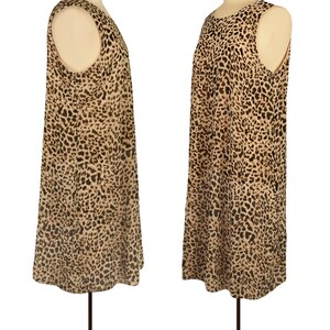 May include: A sleeveless dress with a leopard print pattern in shades of brown and beige. The dress has a loose fit and a rounded neckline.