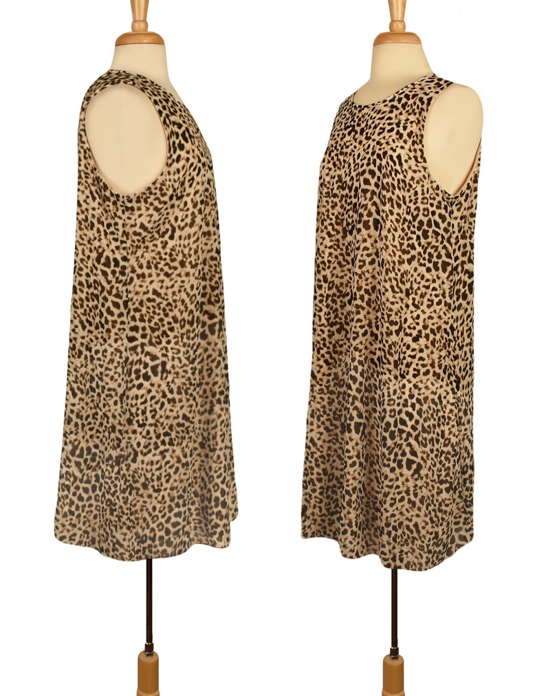 May include: A sleeveless dress with a leopard print pattern in shades of brown and beige. The dress has a loose fit and a rounded neckline.