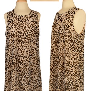 May include: A sleeveless, knee-length dress with a leopard print pattern. The dress is made of a sheer fabric and has a round neckline. The dress is on a mannequin and the brand name "Calvin Klein" is visible at the top of the image.