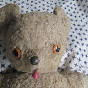 Vintage teddy bear, Tan colored, Good Condition, red plastic tongue, tin painted eyes, metal nose, NO open seams, Needs a good washing,