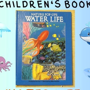 May include: A hardcover children's book titled Nature Pop-Ups Water Life with a blue cover featuring a colorful underwater scene with an orange octopus, yellow fish, and coral reef. The text reads Nature Pop-Ups Water Life, Written by Ken Hoy, Illustrated by Mike Peterkin.