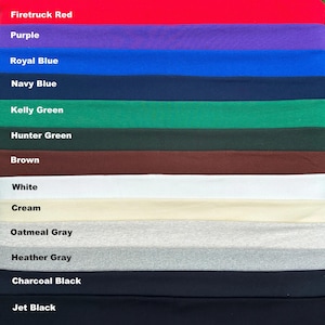 Puede incluir: Una paleta de colores con muestras de tela en varios tonos. Los colores incluyen Rojo Bomberos, Púrpura, Azul Real, Azul Marino, Verde Kelly, Verde Cazador, Marrón, Blanco, Crema, Gris Avena, Gris Heather, Negro Carbón y Negro Azabache.