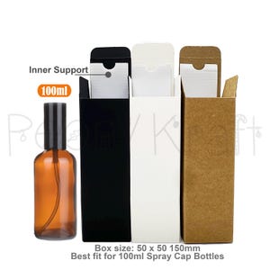 May include: A 100ml amber glass spray bottle with a black cap next to three tall rectangular cardboard boxes in black, white, and kraft brown. Each box features an inner support and measures 50 x 50 x 150mm, designed for 100ml spray bottles.