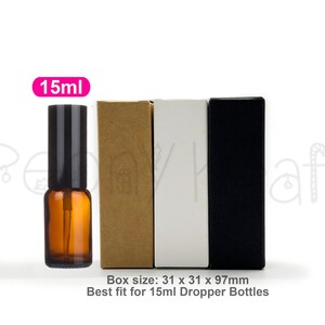 May include: An amber glass bottle with a black dropper cap next to three rectangular boxes in kraft brown, white, and black. A pink label reads 15ml. Text below states: Box size: 31 x 31 x 97mm. Best fit for 15ml Dropper Bottles.