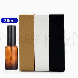 May include: An amber glass spray bottle with a black cap, alongside three rectangular boxes in brown, white, and black. The bottle is labelled "30ml".