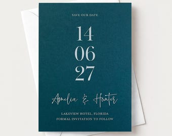 May include: A dark teal rectangular save the date card with white text reading SAVE OUR DATE, 14 06 27, Amelia & Hunter, Lakeview Hotel, Florida, and Formal Invitation to Follow, resting on top of a plain white envelope.