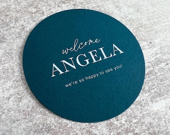 Round place cards, teal personalised wedding guest names, custom circle reception table setting