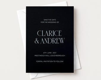 May include: A black rectangular save the date card with white text that reads: SAVE THE DATE FOR THE WEDDING OF CLARICE & ANDREW 6TH JUNE 2027 PRESTWOLD HALL, LOUGHBOROUGH FORMAL INVITATION TO FOLLOW. The card is placed on top of a white envelope.