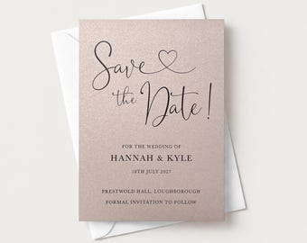 May include: A rose gold shimmer card with black text reading Save the Date! for the wedding of Hannah & Kyle, 18th July 2027, Prestwold Hall, Loughborough, formal invitation to follow, resting on a plain white envelope.