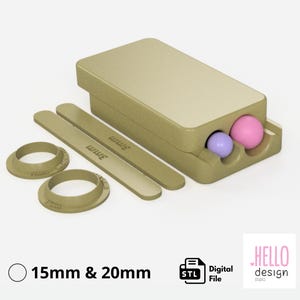 Pode incluir: Uma caixa retangular bege com duas peças planas de 3 mm de comprimento e duas peças circulares com o texto "15mm & 20mm". A caixa tem dois orifícios com uma bola rosa e uma roxa no interior. A imagem também inclui o texto "Digital File" e "HELLO design studio".