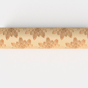 May include: A beige cylinder with a repeating pattern of brown floral designs.