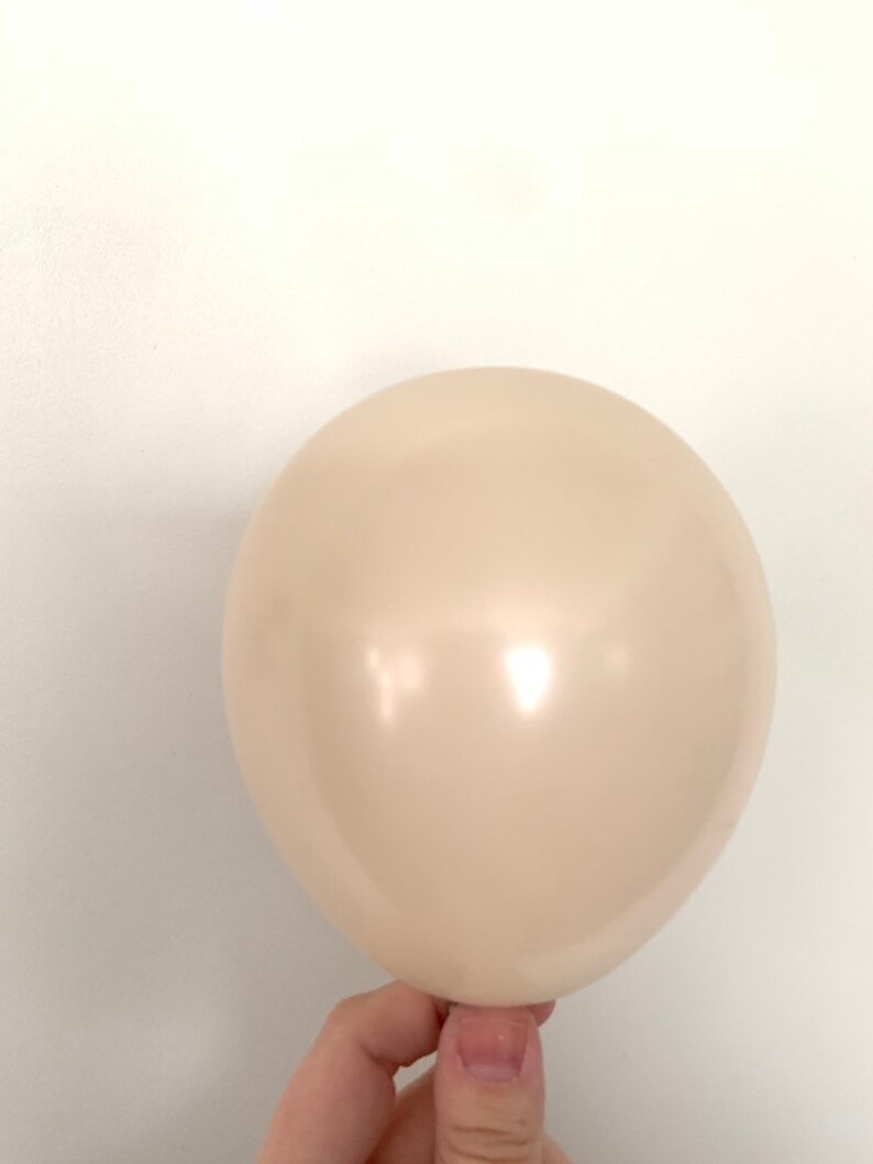 May include: A single, off-white balloon.