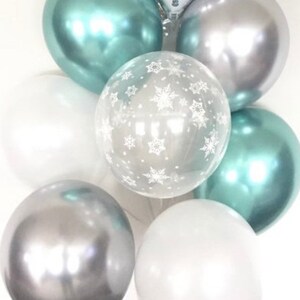 May include: A cluster of balloons in silver, white, and teal. Some balloons have a snowflake pattern.