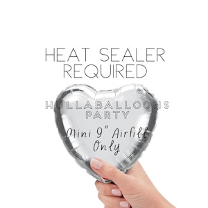 May include: A silver heart-shaped balloon with the text "Hullaballoons Party Mini 9" Airfill Only" and the text "Heat Sealer Required" above the balloon.