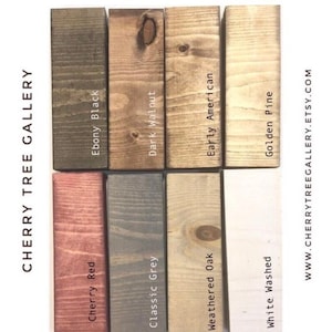 May include: A color palette of wood stain samples, including Ebony Black, Dark Walnut, Early American, and Golden Pine. The samples are arranged vertically, with the text "CHERRY TREE GALLERY" and website address visible.