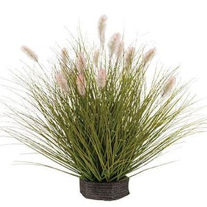 May include: A green artificial grass plant with white feathery flower heads in a brown pot.