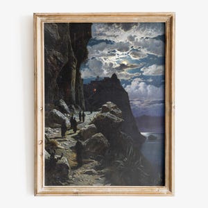 May include: A framed vintage print shows a moonlit coastal scene. Figures in dark robes walk along a cliffside path, lit by the moon and lanterns. The artwork features a dramatic sky and a distant town, evoking a sense of mystery.