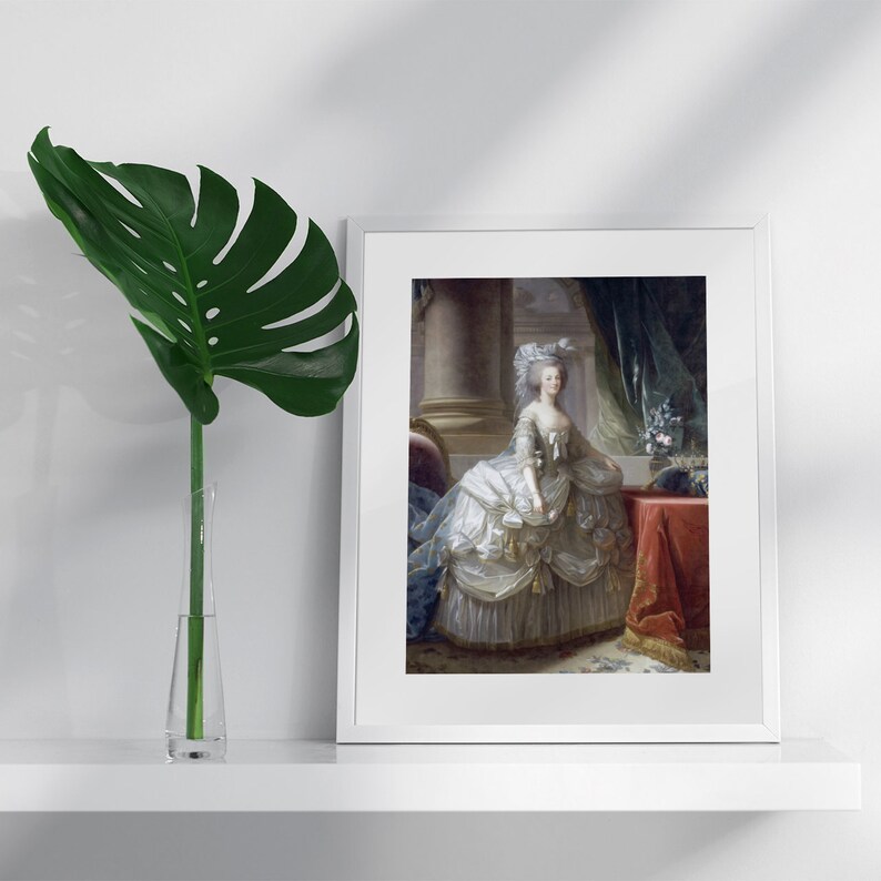 May include: A framed painting of a woman in a white and gold dress, standing in a room with a red and gold chair and a red table. The woman is wearing a white wig and a pearl necklace. The painting is set against a white background.