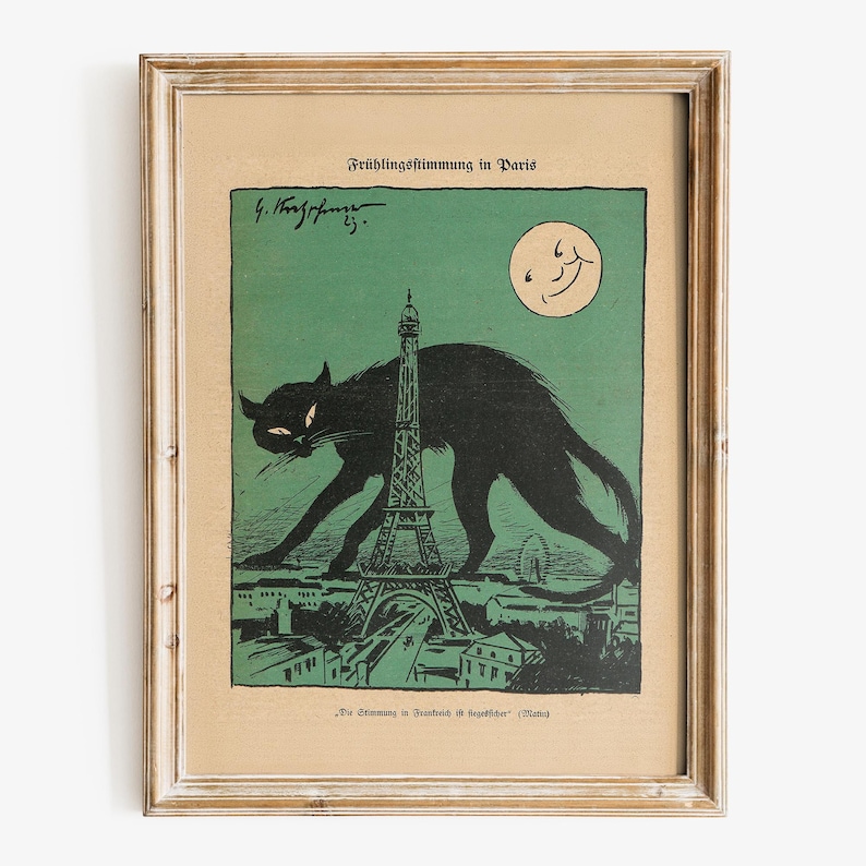 Puede incluir: Impresi&oacute;n vintage enmarcada que presenta un gato negro frente a la Torre Eiffel en Par&iacute;s. La obra de arte tiene una combinaci&oacute;n de colores verde y beige, con una luna sonriente en el cielo. El texto "Fr&uuml;hlingsstimmung in Paris" est&aacute; en la parte superior.