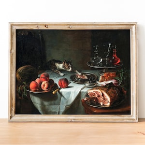 May include: An oil painting in a wooden frame depicts a still life with a cat, fruit, and food. The cat is brown and white and is looking at a piece of meat on a silver plate. There are peaches and a melon on a table with a silver platter of food. The painting is set against a dark background.