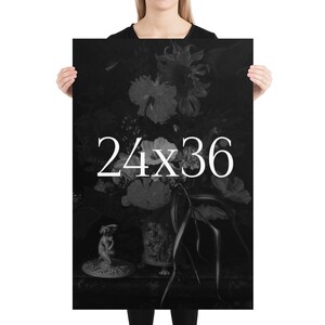 May include: Black and white poster print of a still life featuring a vase of flowers with a small statue in the foreground. The text "24x36" is printed in white on the poster.