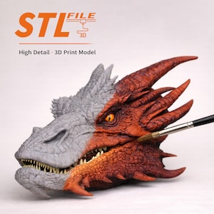 May include: A detailed 3D print model of a dragon's head, half painted in gray and the other half in shades of red and orange. The model has sharp teeth and an intense orange eye. The text "STL FILE 3D" and "High Detail - 3D Print Model" are visible.