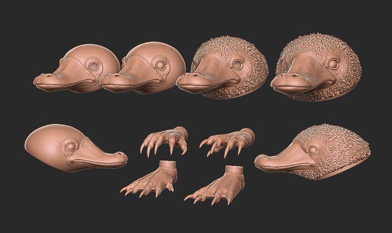 May include: A collection of brown platypus head and body parts, including heads, feet, and claws, arranged against a dark background. The detailed sculptures showcase the unique features of the platypus.