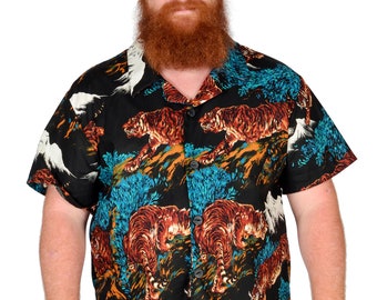 May include: A man with a red beard is wearing a black short-sleeved shirt with a colorful tiger print. The shirt has a button-up collar and a relaxed fit.