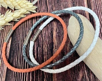 The 3 white, silver and salmon braided leather bracelets