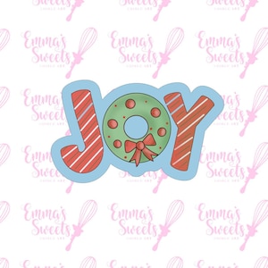 May include: A blue cookie cutter in the shape of the word "JOY" with a candy cane design. The "O" is replaced with a green wreath with a red bow.