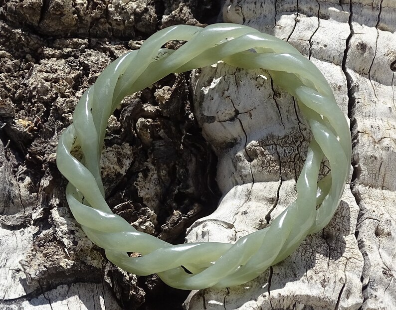 May include: A green jade bracelet with a twisted rope design.