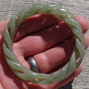 May include: A green jade bangle with a twisted rope design.