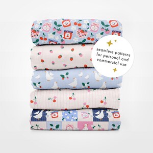 May include: A stack of six rolled fabric pieces with various patterns. The patterns include strawberries, cherries, jam jars, and geese. The top fabric has the text "seamless patterns for personal and commercial use".