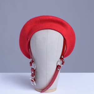 Red wool beret with translucent red pvc harness straps and buckle