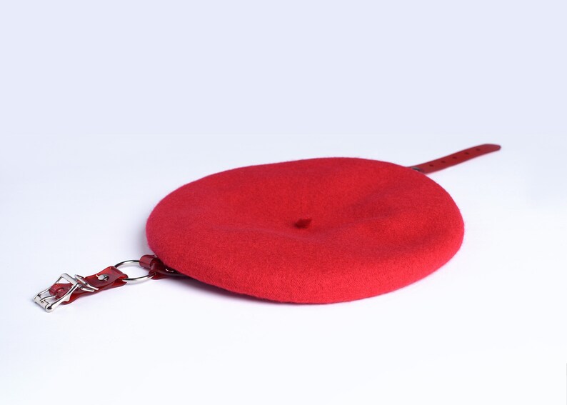 Red wool beret with translucent red pvc harness straps and buckle