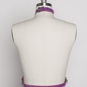 May include: A purple leather belt with a silver buckle. The belt is on a white mannequin.