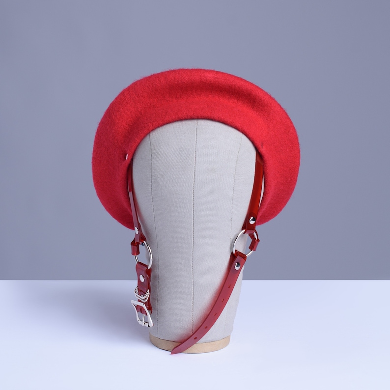 Red wool beret with translucent red pvc harness straps and buckle