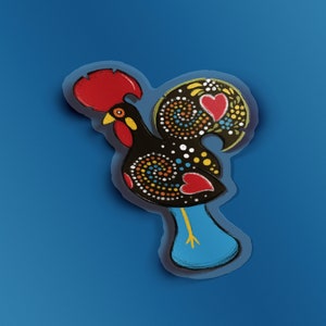 May include: A colorful rooster with a red comb and wattle, black body with white and yellow polka dots, and blue legs. The rooster is a traditional Portuguese symbol.