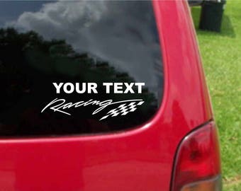 May include: White vinyl decal with the text "YOUR TEXT Racing" and a chequered flag design. The decal is applied to the rear window of a red car.