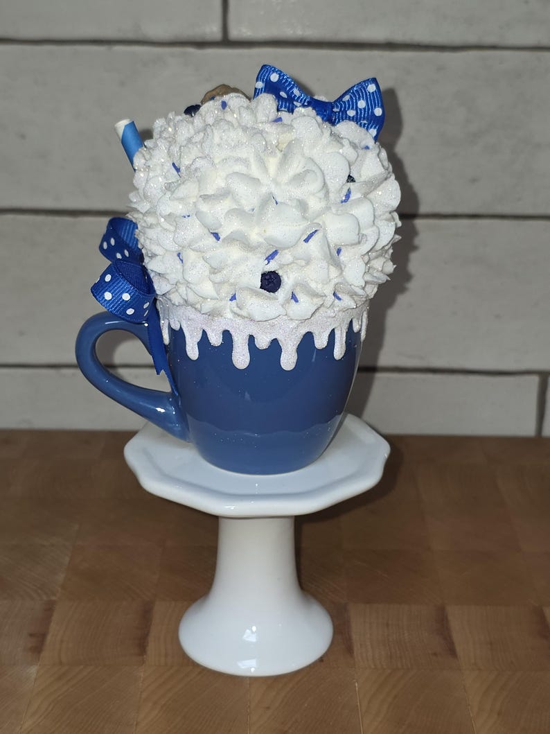 Back view of blueberry fake bake mug showing hand-placed sprinkles and faux blueberries on whipped cream topping for kitchen display.