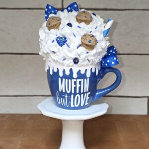 Blueberry mug fake bake decor with faux muffins, whipped cream, and hand-placed sprinkles for tiered trays or cottagecore kitchens.
