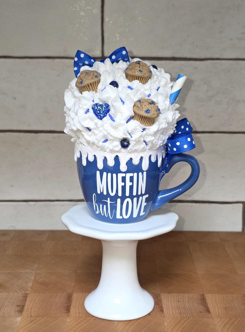 Blueberry mug fake bake decor with faux muffins, whipped cream, and hand-placed sprinkles for tiered trays or cottagecore kitchens.