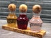 BONJOUR – 3 smaller glass carafes on an olive wood base with olive wood balls as a closure   