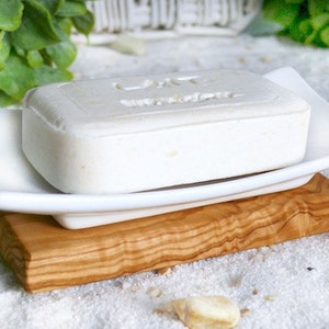 Porcelain soap dish on olive wood plate