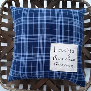 May include: Blue and white plaid pillow with a beige tag that says "Love ya Bunches Grandma".