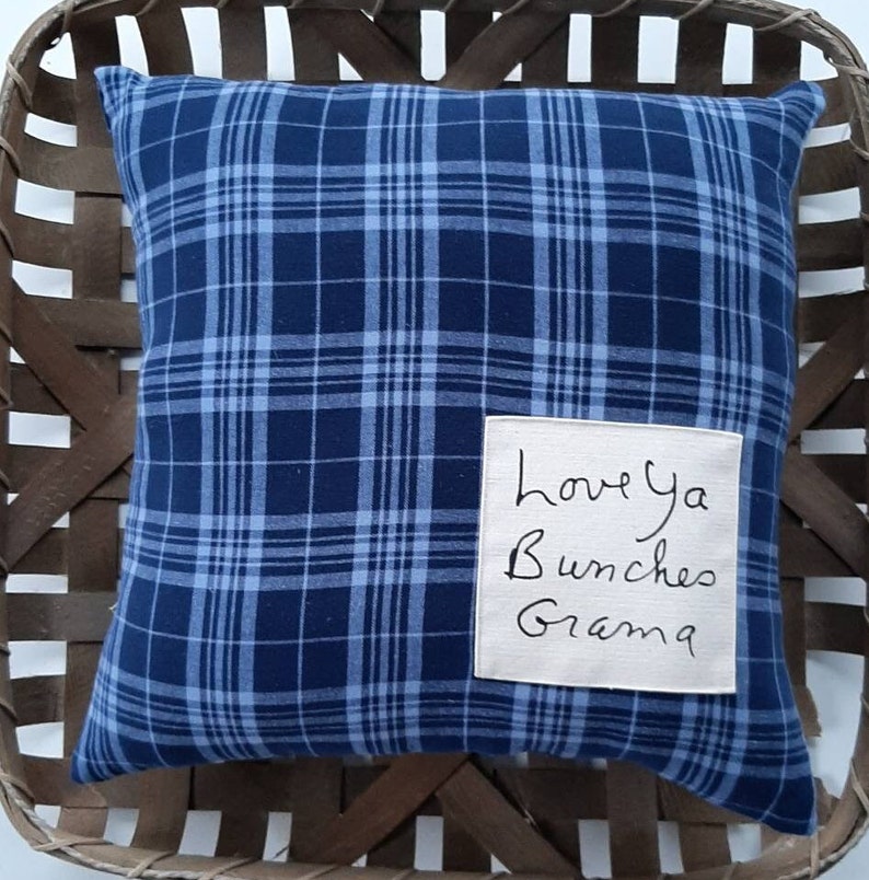 May include: Blue and white plaid pillow with a beige tag that says "Love ya Bunches Grandma".