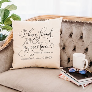 May include: A white throw pillow with black text that reads "I have found the one my soul loves."  The text also includes a Bible verse reference "Song of Solomon 3:4" and a personalized message "Samantha & Jason 9-16-23".